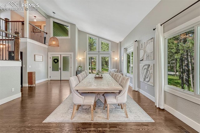 970 Bend In The Trail Rd, Monument, CO 80132 - dining space featuring french doors, high vaulted ceiling, stairs, and dark wood-style flooring