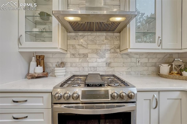 970 Bend In The Trail Rd, Monument, CO 80132 - kitchen featuring stainless steel gas stove, wall chimney range hood, and white cabinets