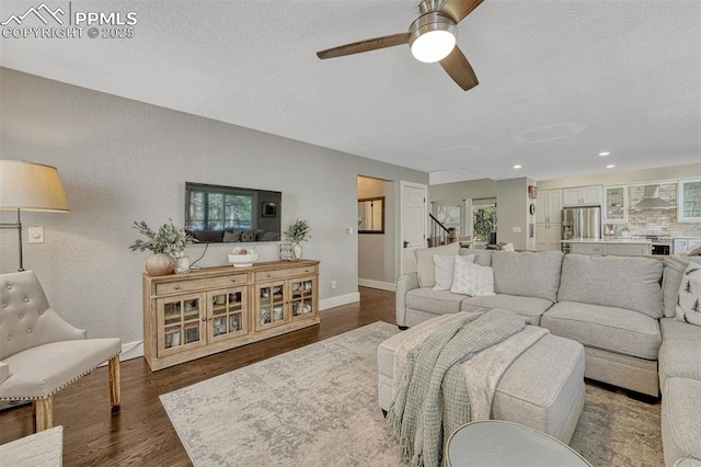 970 Bend In The Trail Rd, Monument, CO 80132 - living area with ceiling fan, dark wood-style flooring, stairs, healthy amount of natural light, and recessed lighting