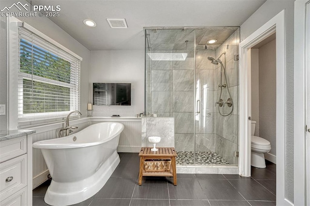 970 Bend In The Trail Rd, Monument, CO 80132 - bathroom featuring a shower stall, a freestanding tub, tile patterned flooring, vanity, and recessed lighting