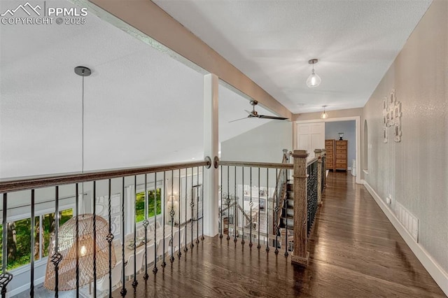970 Bend In The Trail Rd, Monument, CO 80132 - hall featuring wood finished floors, a textured ceiling, and an upstairs landing