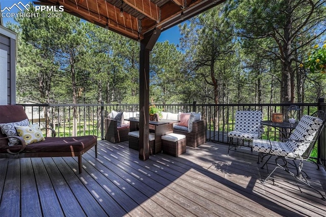 970 Bend In The Trail Rd, Monument, CO 80132 - wooden deck featuring an outdoor living space and view of scattered trees