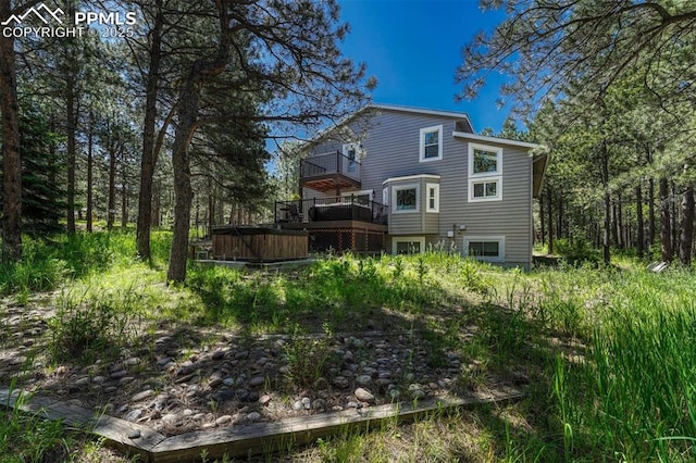 970 Bend In The Trail Rd, Monument, CO 80132 - back of house featuring a hot tub, a balcony, and a deck