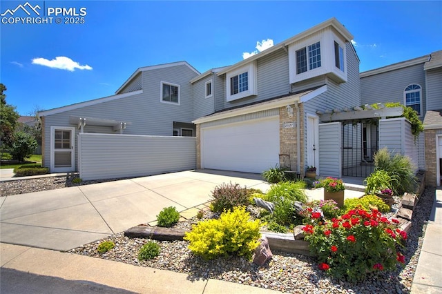 2527 Elite Ter, Colorado Springs, CO 80920 - view of front facade featuring concrete driveway, a garage, brick siding, and a pergola