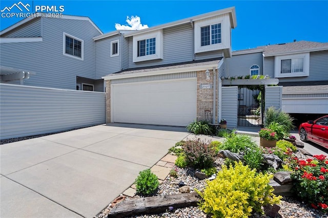 2527 Elite Ter, Colorado Springs, CO 80920 - view of front of house featuring concrete driveway, a garage, and brick siding
