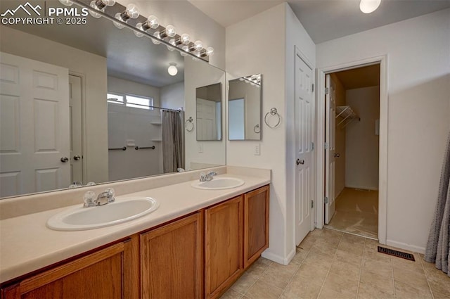 12874 Oakland Hills Rd, Peyton, CO 80831 - full bath featuring double vanity, a shower with curtain, and tile patterned floors