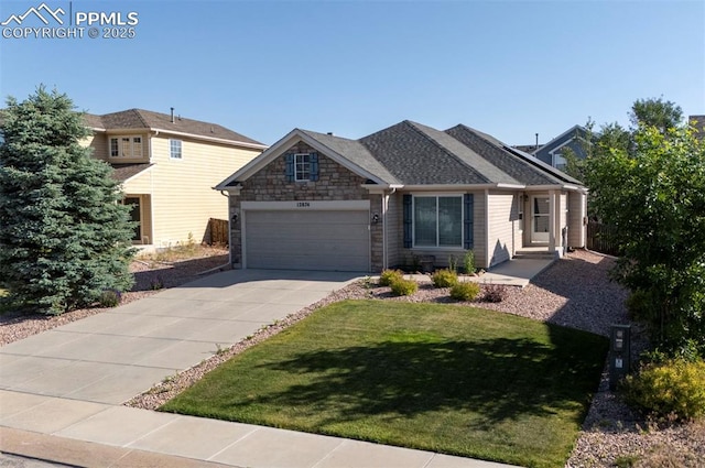 12874 Oakland Hills Rd, Peyton, CO 80831 - view of front of home featuring an attached garage, a front yard, driveway, and stone siding