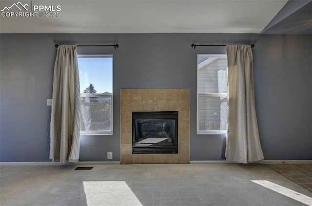 12874 Oakland Hills Rd, Peyton, CO 80831 - unfurnished living room featuring carpet flooring and a tile fireplace