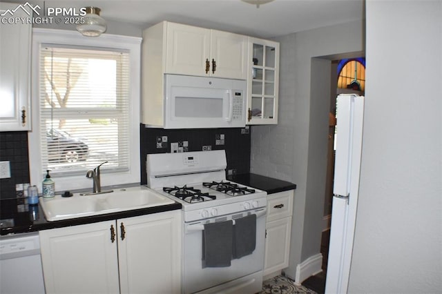 305 W 2nd St, Florence, CO 81226 - kitchen featuring white appliances, tasteful backsplash, and white cabinets