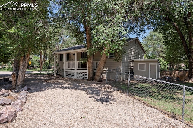 1633 N Chestnut St, Colorado Springs, CO 80907 - single story home featuring a porch and a shed