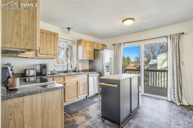 1633 N Chestnut St, Colorado Springs, CO 80907 - kitchen featuring dishwasher, light brown cabinets, a textured ceiling, and a kitchen island