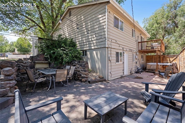 1633 N Chestnut St, Colorado Springs, CO 80907 - view of patio / terrace with a hot tub, outdoor dining area, and a deck