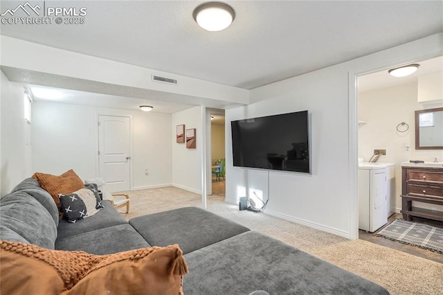 1633 N Chestnut St, Colorado Springs, CO 80907 - carpeted living area featuring washer and dryer and baseboards