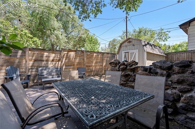 1633 N Chestnut St, Colorado Springs, CO 80907 - fenced backyard featuring a storage unit, outdoor dining area, and a patio area