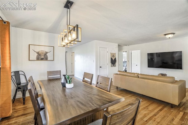 1633 N Chestnut St, Colorado Springs, CO 80907 - dining area with wood finished floors and a chandelier