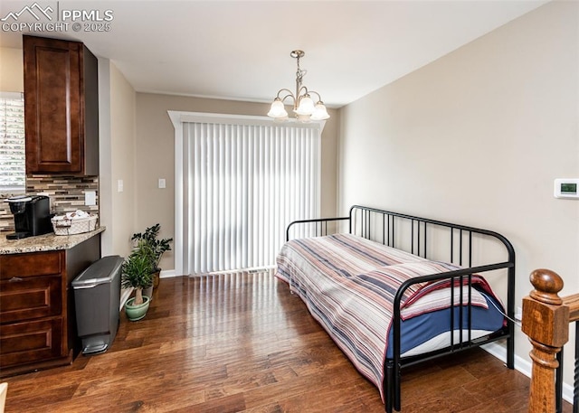 3730 Deep Haven Dr, Colorado Springs, CO 80920 - bedroom with a chandelier and dark wood-style floors