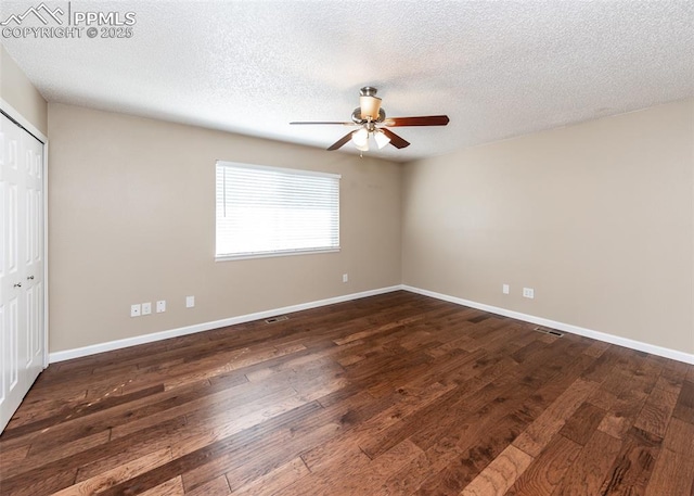 3730 Deep Haven Dr, Colorado Springs, CO 80920 - unfurnished bedroom with dark wood-style floors, a textured ceiling, a closet, and ceiling fan