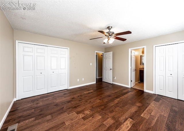 3730 Deep Haven Dr, Colorado Springs, CO 80920 - unfurnished bedroom with dark wood-style floors, multiple closets, a textured ceiling, ceiling fan, and ensuite bath
