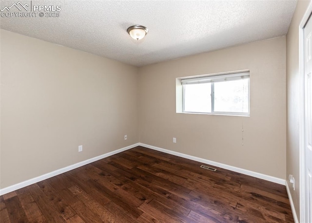 3730 Deep Haven Dr, Colorado Springs, CO 80920 - unfurnished room featuring dark wood-style flooring and a textured ceiling