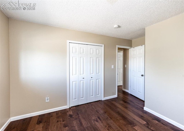 3730 Deep Haven Dr, Colorado Springs, CO 80920 - unfurnished bedroom featuring dark wood-type flooring, a closet, and a textured ceiling