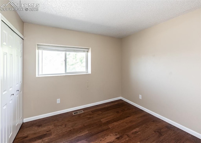 3730 Deep Haven Dr, Colorado Springs, CO 80920 - unfurnished bedroom with a closet, wood finished floors, and a textured ceiling