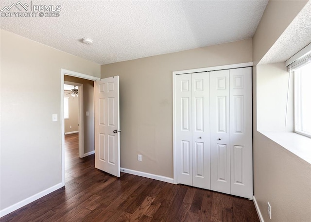 3730 Deep Haven Dr, Colorado Springs, CO 80920 - unfurnished bedroom featuring dark wood-style floors, a closet, and a textured ceiling