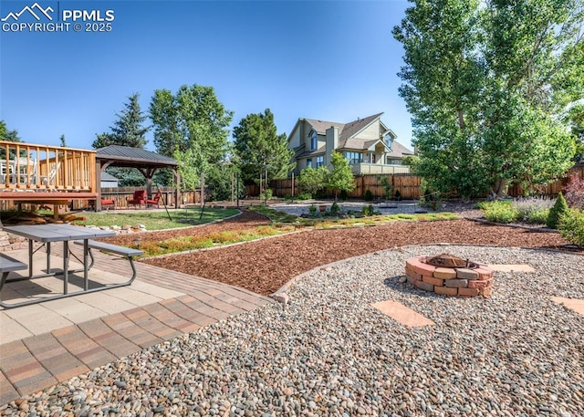 3730 Deep Haven Dr, Colorado Springs, CO 80920 - fenced backyard featuring a gazebo, a fire pit, a patio area, and a wooden deck
