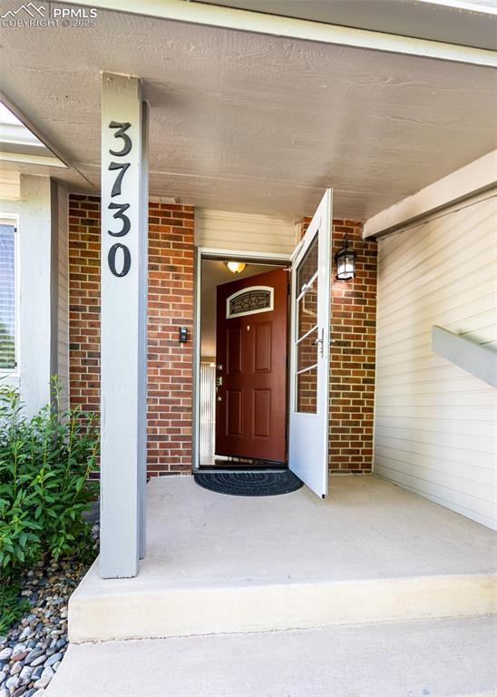 3730 Deep Haven Dr, Colorado Springs, CO 80920 - entrance to property featuring brick siding and a porch