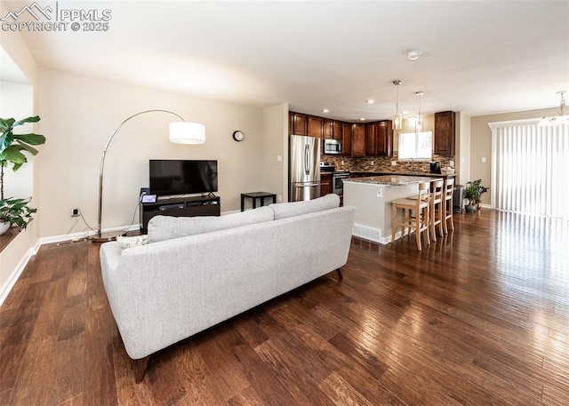 3730 Deep Haven Dr, Colorado Springs, CO 80920 - living room featuring dark wood-style flooring and recessed lighting