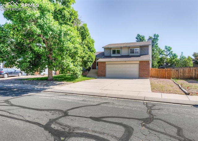 3730 Deep Haven Dr, Colorado Springs, CO 80920 - traditional-style home with driveway, a chimney, brick siding, an attached garage, and roof with shingles