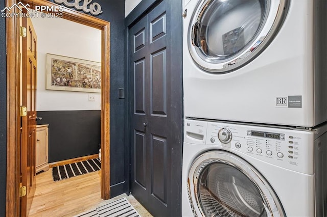 18971 Shadowood Dr, Monument, CO 80132 - washroom with stacked washing machine and dryer and wood finished floors