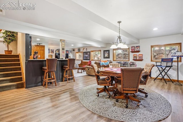 18971 Shadowood Dr, Monument, CO 80132 - dining area featuring a dry bar, light wood-type flooring, recessed lighting, stairs, and a chandelier