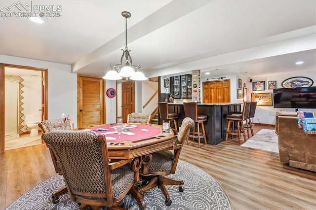 18971 Shadowood Dr, Monument, CO 80132 - dining room featuring a bar, light wood-style flooring, stairway, and recessed lighting