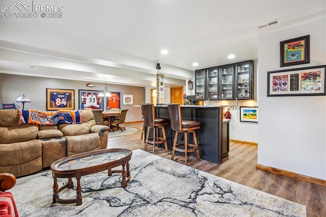 18971 Shadowood Dr, Monument, CO 80132 - living area featuring a bar, light wood-style floors, and recessed lighting