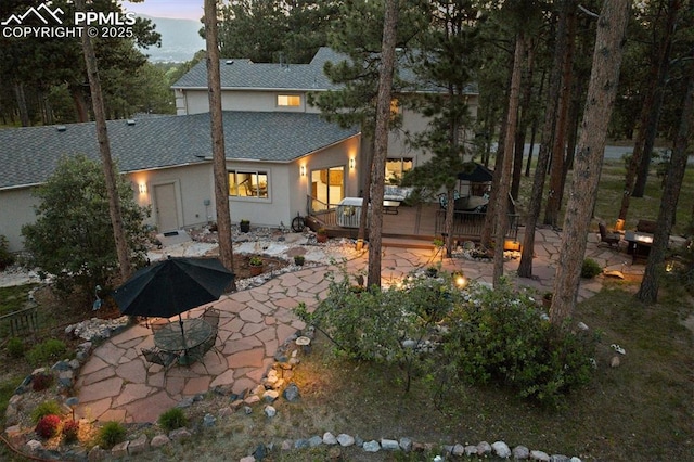 18971 Shadowood Dr, Monument, CO 80132 - back of property with a patio area, stucco siding, roof with shingles, and a deck
