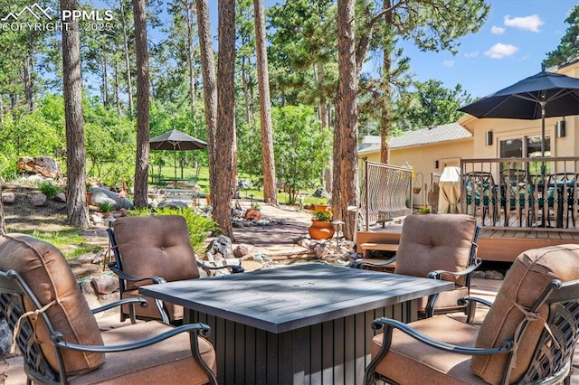 18971 Shadowood Dr, Monument, CO 80132 - view of patio with a deck and view of wooded area