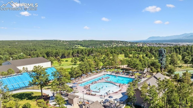 18971 Shadowood Dr, Monument, CO 80132 - aerial view of a heavily wooded area and a mountain backdrop