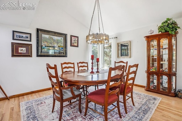 18971 Shadowood Dr, Monument, CO 80132 - dining space featuring a chandelier, light wood-style floors, and vaulted ceiling