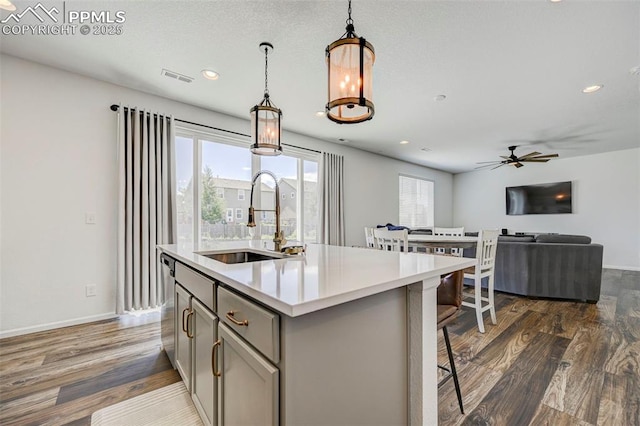 6237 Bodacious Cir, Colorado Springs, CO 80923 - kitchen featuring gray cabinetry, decorative light fixtures, dark wood finished floors, ceiling fan, and light countertops
