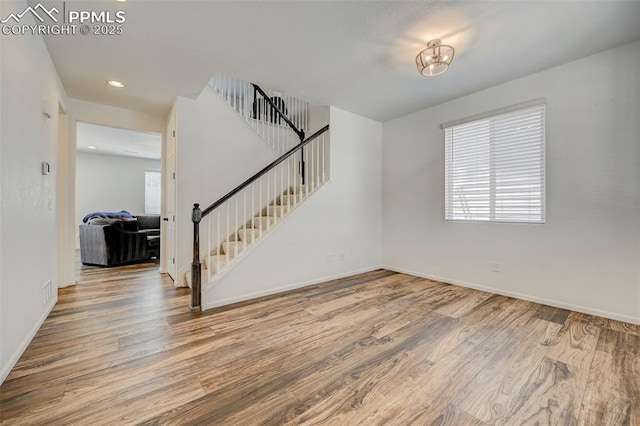 6237 Bodacious Cir, Colorado Springs, CO 80923 - unfurnished living room featuring wood finished floors, stairs, and recessed lighting