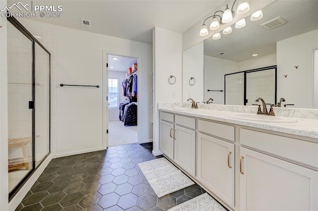 6237 Bodacious Cir, Colorado Springs, CO 80923 - bathroom with a stall shower, double vanity, and tile patterned floors