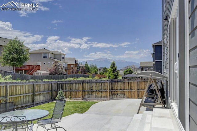 6237 Bodacious Cir, Colorado Springs, CO 80923 - fenced backyard with a patio, a residential view, and a mountain view