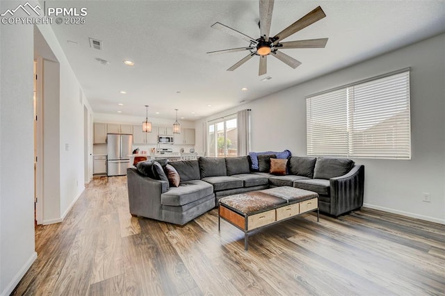 6237 Bodacious Cir, Colorado Springs, CO 80923 - living area featuring light wood-style flooring, a ceiling fan, and recessed lighting
