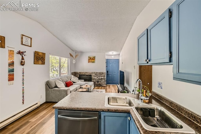 3324 W Kiowa St, Colorado Springs, CO 80904 - kitchen featuring dishwasher, blue cabinets, baseboard heating, open floor plan, and a peninsula