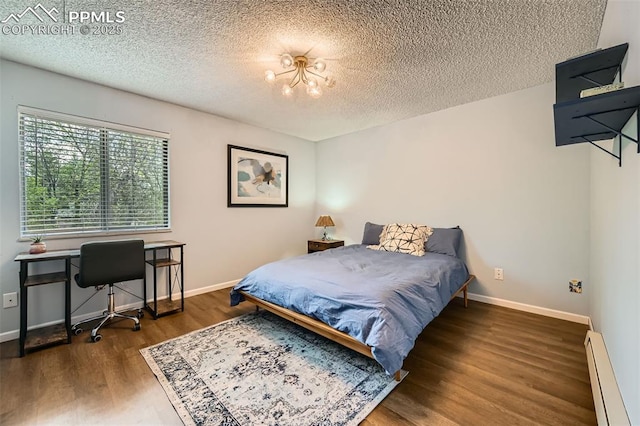 3324 W Kiowa St, Colorado Springs, CO 80904 - bedroom featuring a baseboard heating unit, a textured ceiling, wood finished floors, and an office area