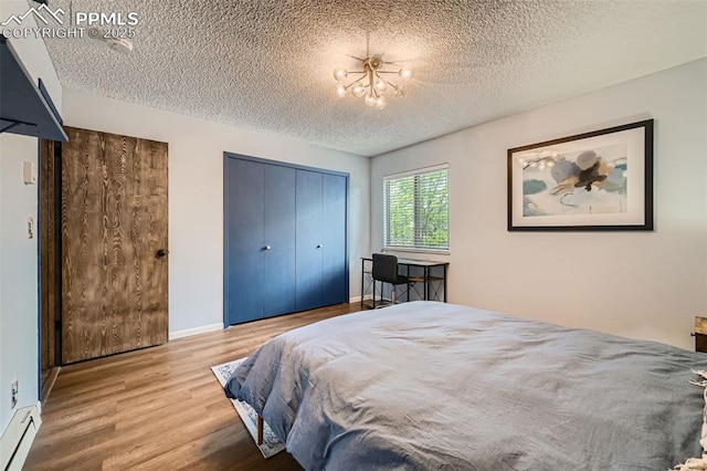 3324 W Kiowa St, Colorado Springs, CO 80904 - bedroom featuring a textured ceiling, wood finished floors, and a closet