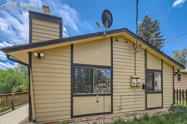3324 W Kiowa St, Colorado Springs, CO 80904 - view of side of property featuring a chimney and a deck