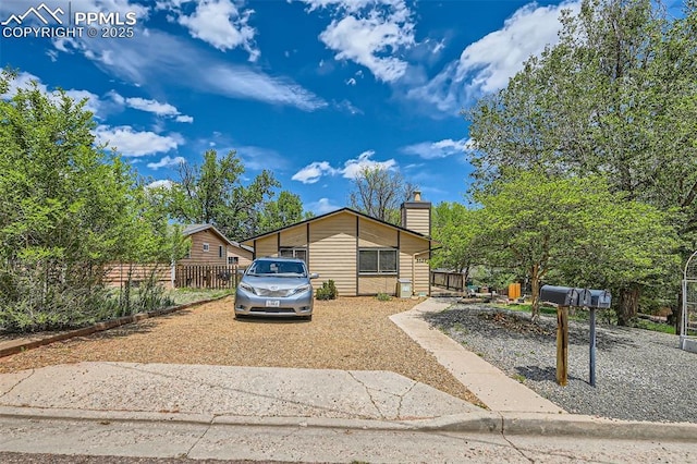 3324 W Kiowa St, Colorado Springs, CO 80904 - view of front of home with gravel driveway and a chimney