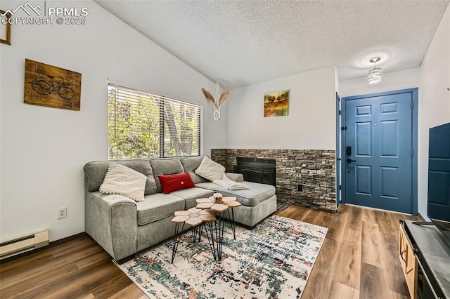 3324 W Kiowa St, Colorado Springs, CO 80904 - living area with a baseboard radiator, a textured ceiling, wood finished floors, a fireplace, and vaulted ceiling
