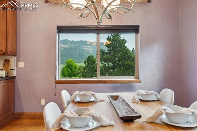 20401 High Pines Dr, Monument, CO 80132 - dining space featuring a chandelier, wood finished floors, and a textured wall